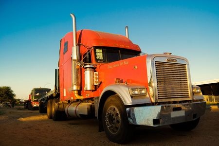 A picture of two commercial trailer trucks.