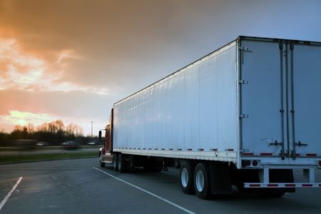 Semi Truck Driving into sunset