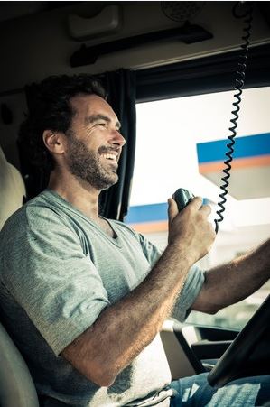 truck driver on radio in truck