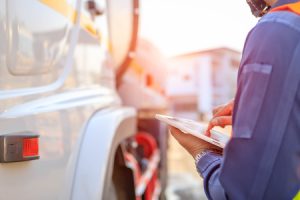 Driver Inspecting Truck