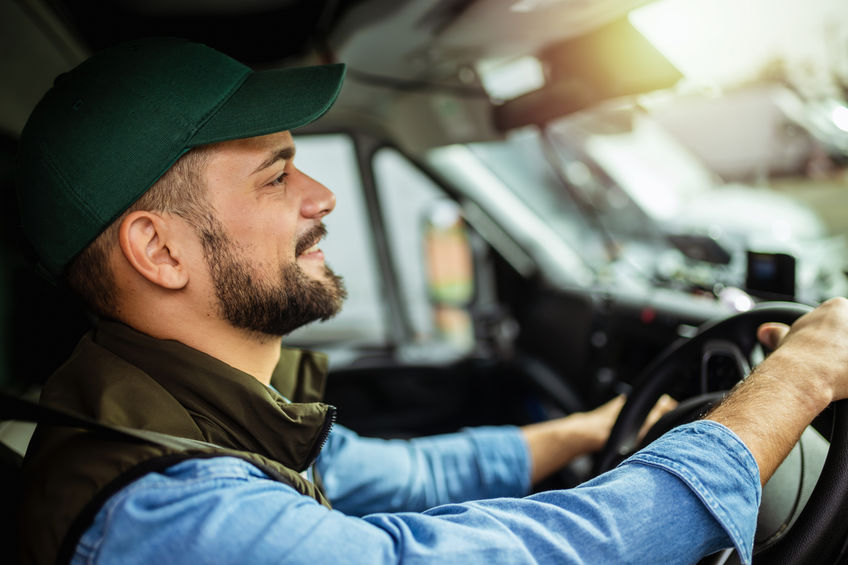 Young truck driver enjoying his new job that a placement agency found for him