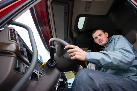 Young male truck driver parking his truck