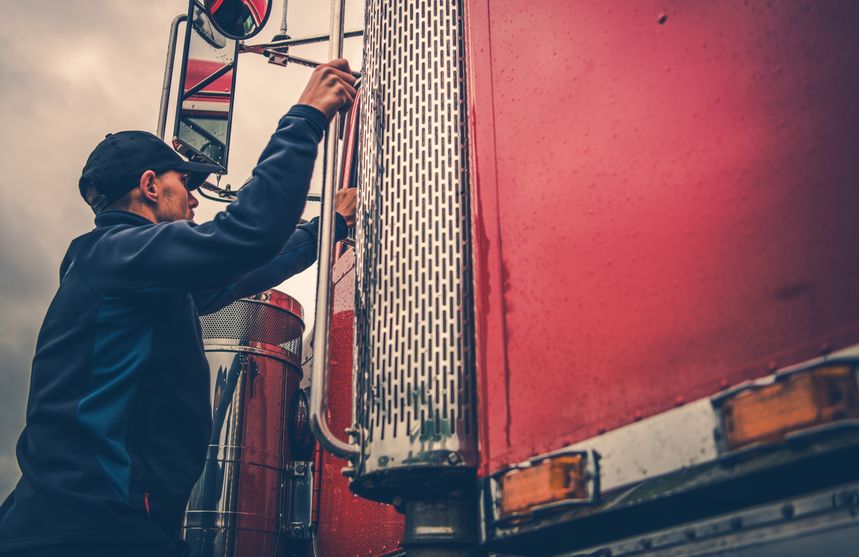 Truck Driver Getting Into Truck