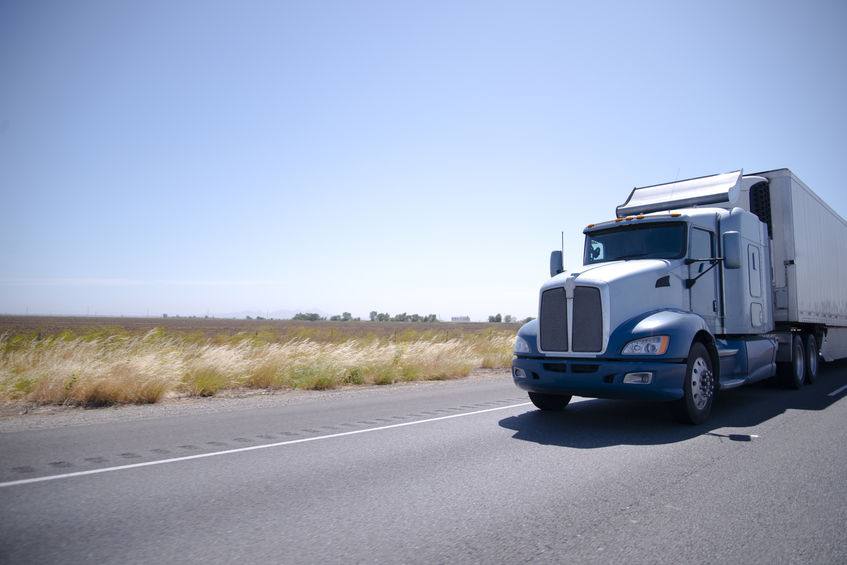 Big rig semi truck with stainless steel spoiler and reefer trail