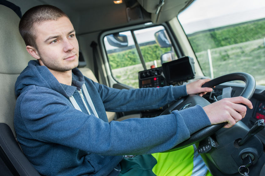 Young man driving commercial truck