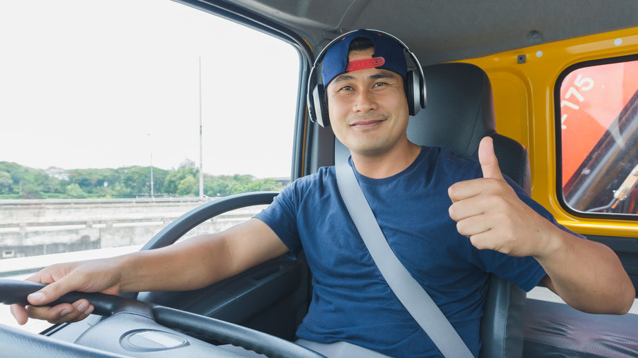 Happy truck driver giving a thumbs up at rest stop