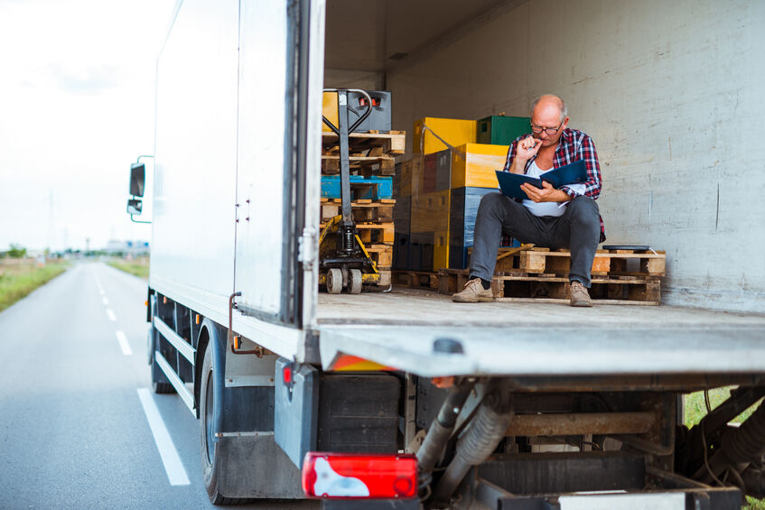 Truck driver taking a break in the back of his cab