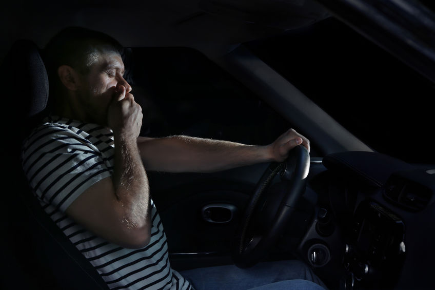 Tired truck driver falling asleep at wheel