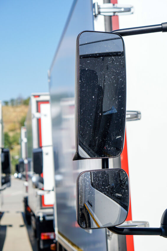 Truck driver checking his rearview mirror