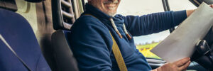 Happy truck driver smiling in cab