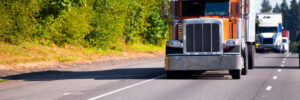 Classic orange semi truck on multilane highway