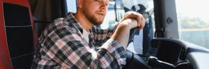 Truck driver who appears to be asleep at the wheel
