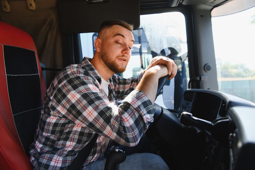 Truck driver who appears to be asleep at the wheel